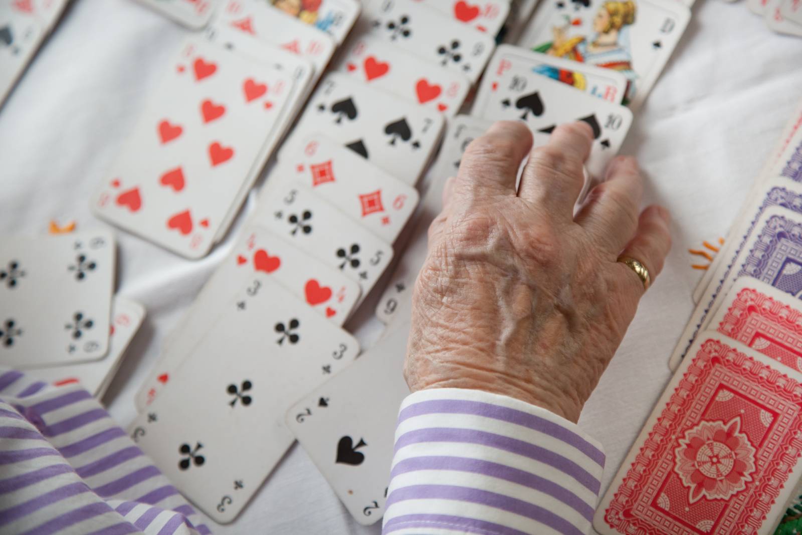 Elderly woman with dementia playing cards.