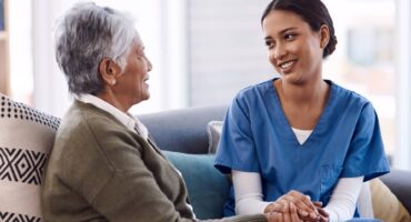 Elderly woman discusses a care plan with her nurse.