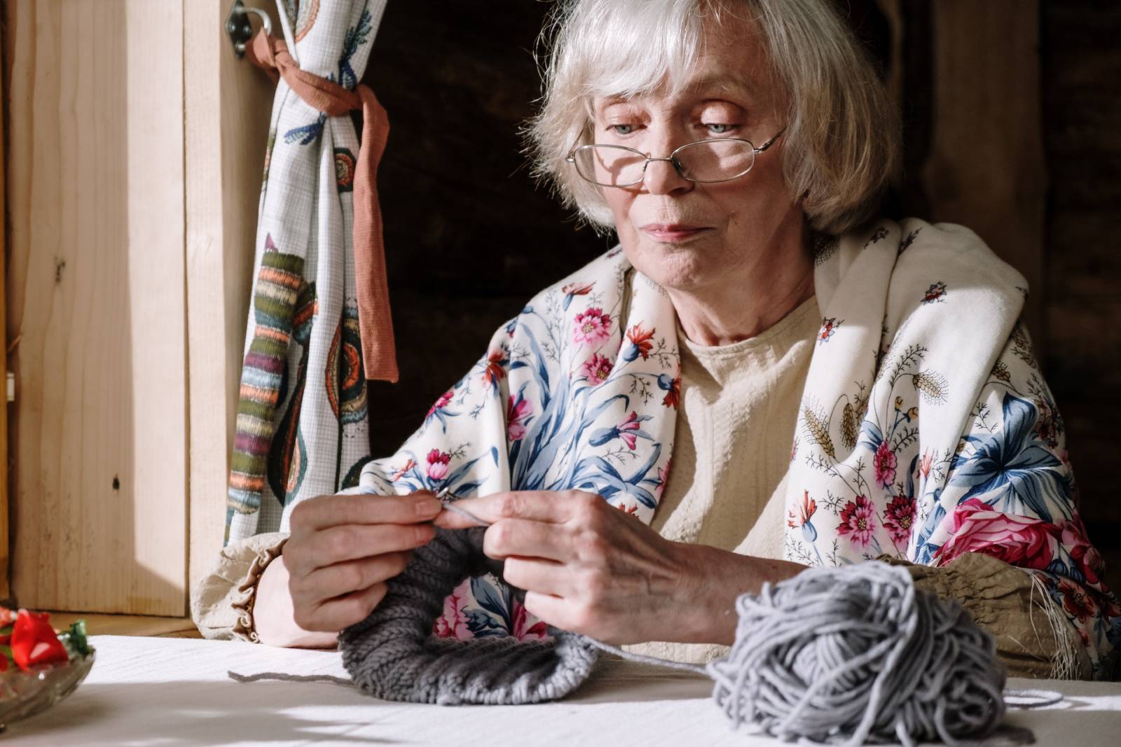 Elderly woman with dementia taking up a hobby in knitting.