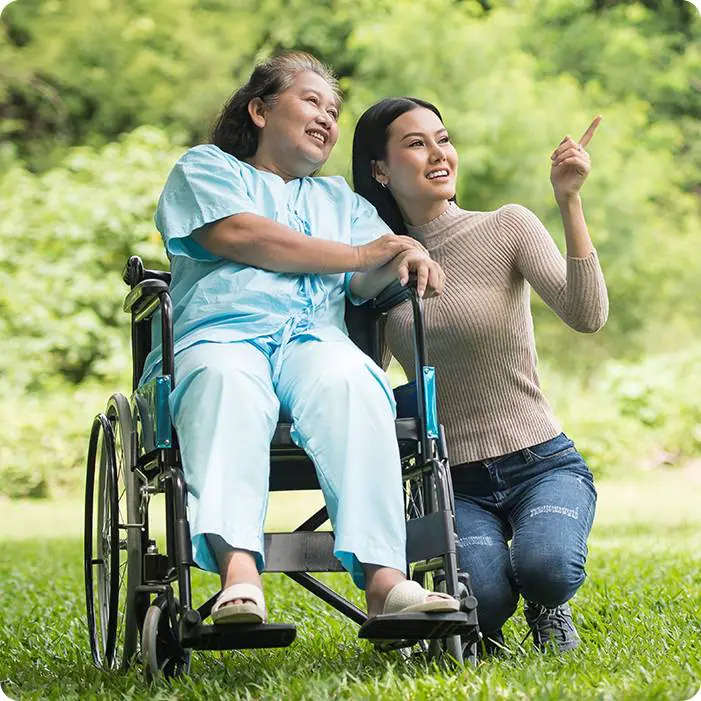 Elderly woman in a wheelchair with a caregiver who is providing private dementia care in Edmonton.